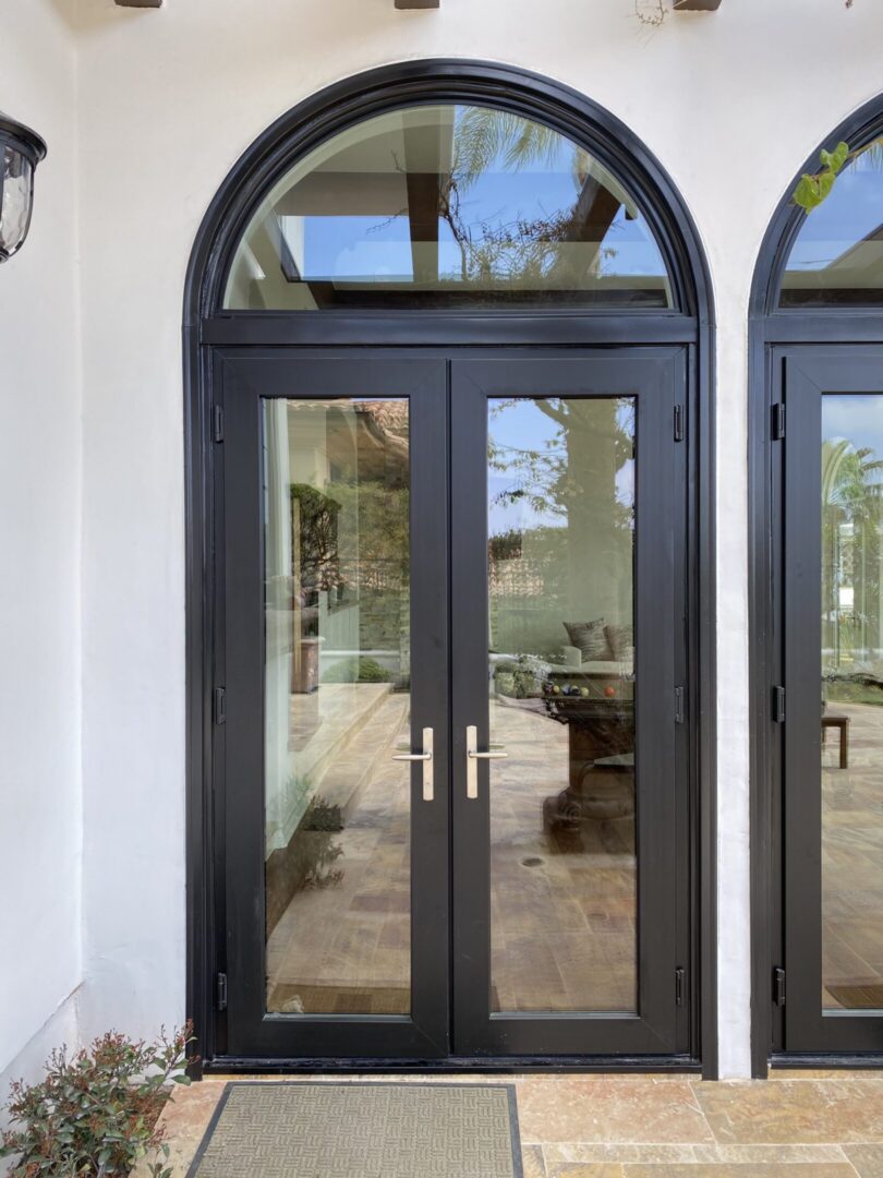 Black arched double glass doors entrance