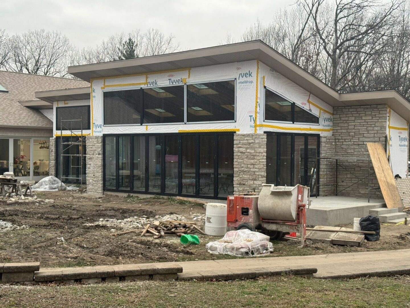 Contemporary home mid-construction with floor-to-ceiling glass