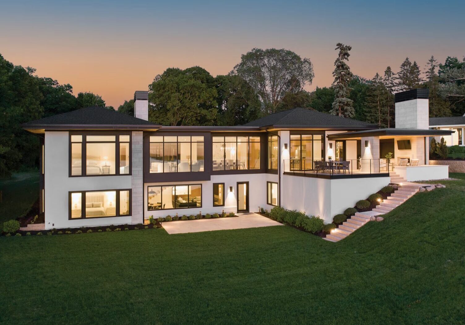 Modern luxury home with large illuminated windows